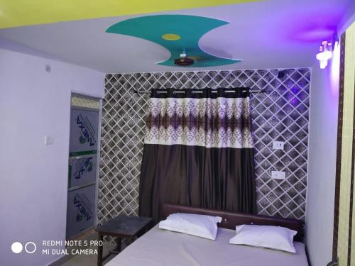 a bedroom with a bed with a star on the ceiling at Nhyn home stay in Varanasi