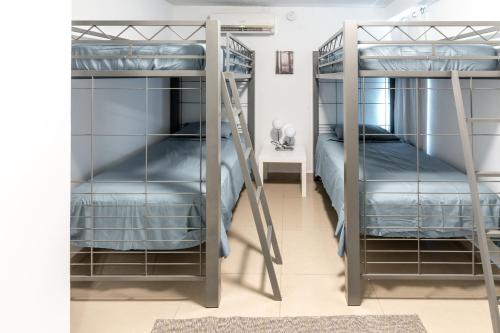 a room with two bunk beds and a desk at Aquaville Dorado Moderna Villa 2 in Dorado