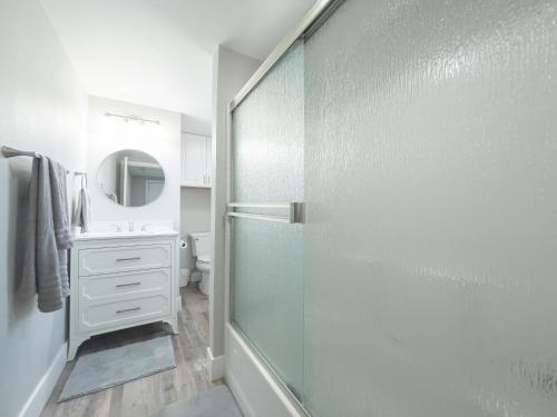 a bathroom with a glass shower and a sink at Country Living-harrison Ranchhr3 in Visalia