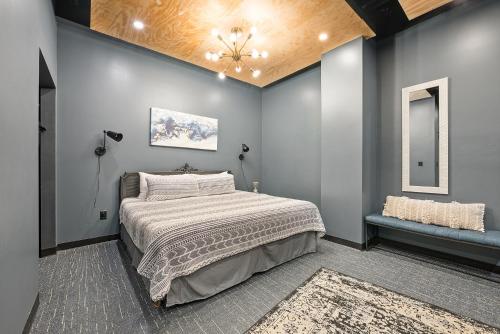 a bedroom with a bed and a ceiling at Indigo Pass Boutique Hotel in Middletown