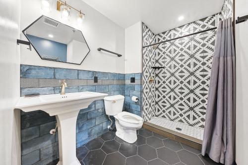 a bathroom with a toilet and a sink and a shower at Indigo Pass Boutique Hotel in Middletown