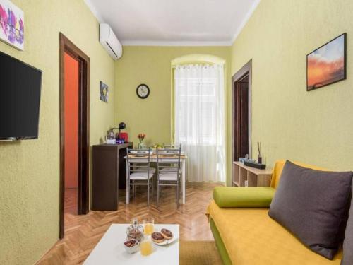 a living room with a couch and a table at Apartman KARESA -Rijeka in Rijeka
