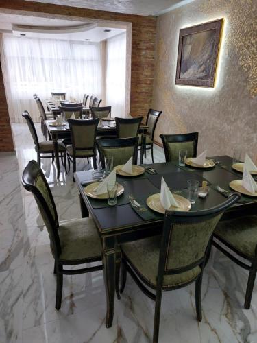 JOKSIM Rooms&Restaurant في Kuršumlija: مطعم فيه طاولات وكراسي في الغرفة
