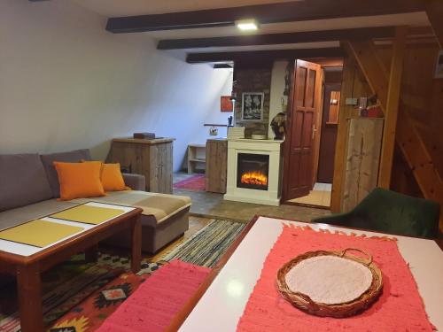 a living room with a couch and a fireplace at Snow Angel Jahorina in Jahorina