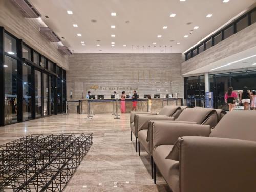 a lobby with a row of chairs in a building at Salinas Premium Resort 1423 Smart in Salinópolis