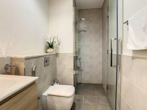 a bathroom with a toilet and a shower at Key View - Golf Vita in Dubai Marina