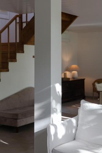 a living room with a couch and a staircase at A Padaria Farmhouse in Cinfães