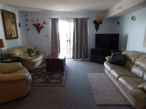 a living room with couches and a flat screen tv at Marylander Condominiums, 90 steps from the beach in Ocean City