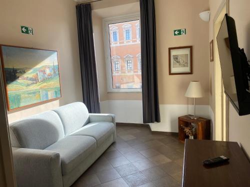 a living room with a couch and a window at 3House in Rome