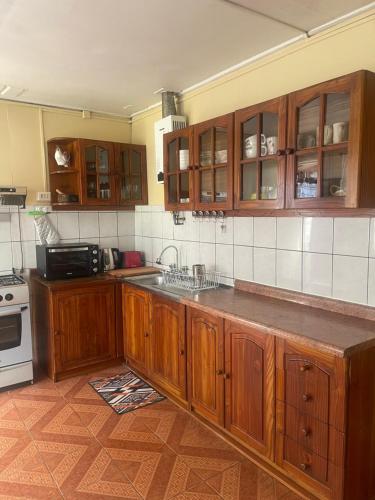 Acogedora casa céntrica en Panguipulli في بانغويبولي: مطبخ بدولاب خشبي وقمة كونتر