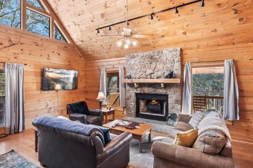 a living room with couches and a fireplace at SunnySierra Cabin in Sevierville