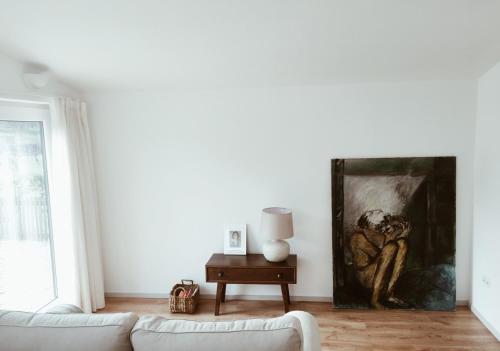 a living room with a couch and a painting on the wall at A Padaria Farmhouse in Cinfães