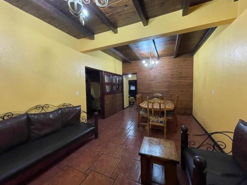 a living room with a couch and a table at Villas Lupita in Mazamitla