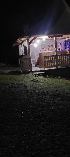 a group of people sleeping in a tent at night at Cabana Gabriela in Gîrda de Sus