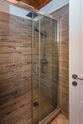 a shower with a glass door in a bathroom at Kassiopi Central House in Kassiopi