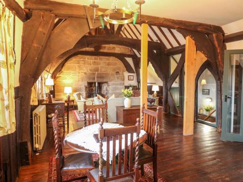 a dining room with a table and chairs and a stone wall at Porter's Lodge in Tamworth