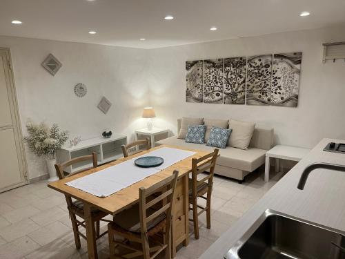 a kitchen and living room with a table and a couch at Centrale56 in Bisceglie