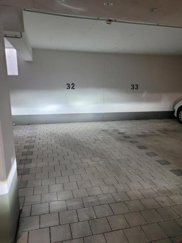 an empty room with a white wall and a tile floor at Traumwohnung Füssen 22 in Füssen