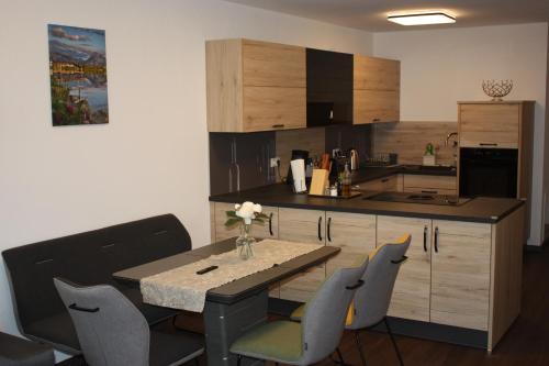 a kitchen with a table and chairs in a room at Traumwohnung Füssen 22 in Füssen