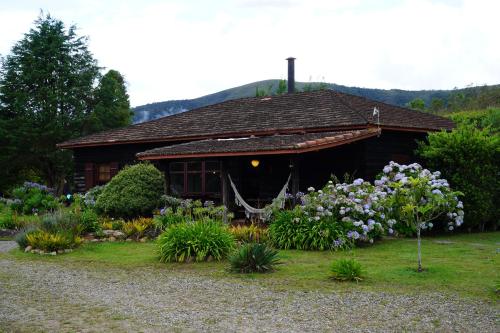 a small house with flowers in front of it at Campos da Bocaina in São José do Barreiro