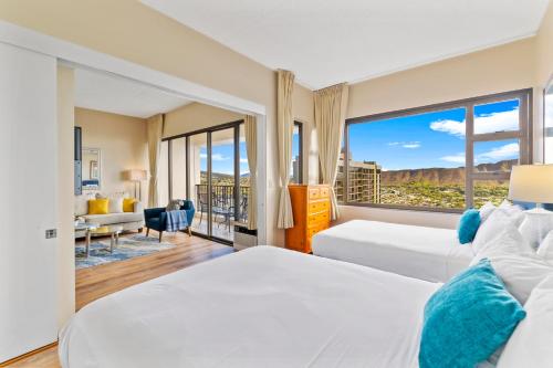 a hotel room with two beds and a large window at Upscale Penthouse with Ocean Views & Free Parking! in Honolulu