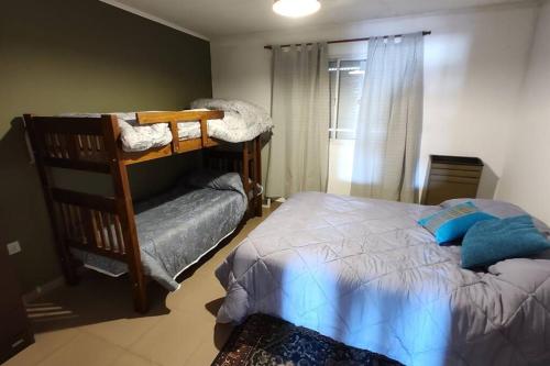 a bedroom with a bed and a bunk bed at Departamento en pleno Centro de Catriel. in Catriel