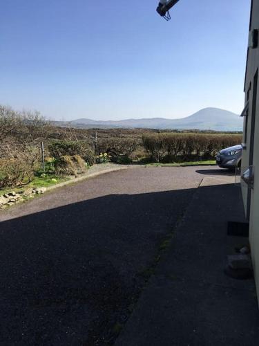 a car parked on the side of a road at Bungalow by the sea in Gortgarriff