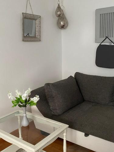 a living room with a couch and a table at Casa Bianca Souterrain in Kappel-Grafenhausen