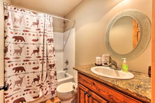 a bathroom with a sink and a shower curtain at Drake Home on Big Thompson River - 3 Mi to Estes! in Estes Park