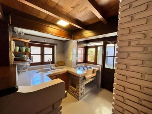 a large kitchen with a sink and a counter at Casita de Villegas in San Martín de los Andes