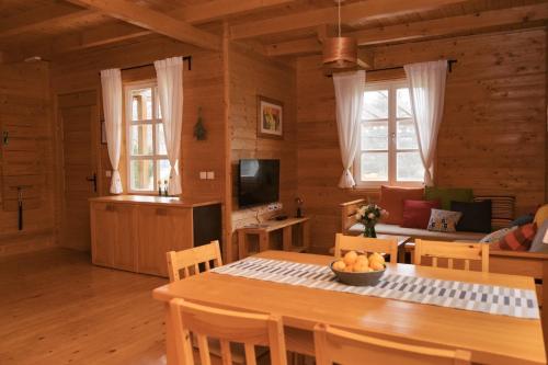 a kitchen and living room with a table and chairs at Holiday Homes Vita Natura in Rakovica