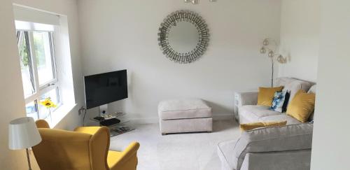 a living room with a couch and a chair at Luxurious First Floor Flat in Dornoch