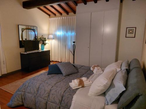 a bedroom with a large bed and a couch at La Casa di Agata Deluxe in Fucecchio