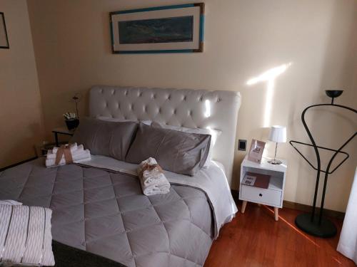 a bedroom with a large white bed with a lamp at La Casa di Agata Deluxe in Fucecchio
