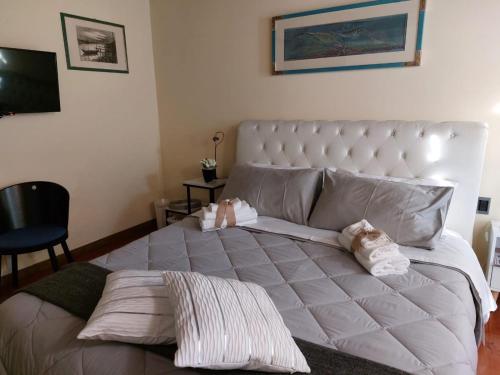 a bedroom with a large bed with towels on it at La Casa di Agata Deluxe in Fucecchio