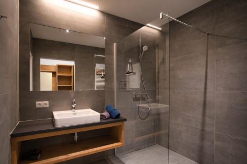 a bathroom with a sink and a shower at Hotel Breilerhof in Schladming