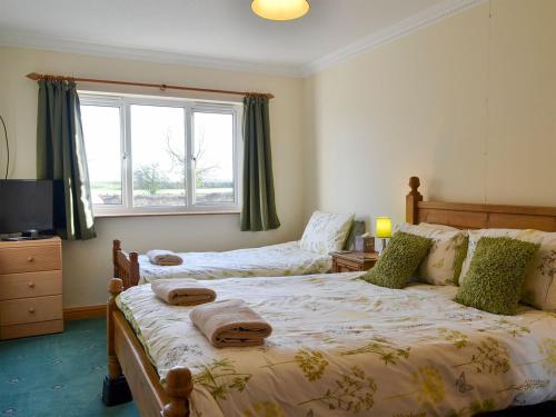 Postel nebo postele na pokoji v ubytování Ivy Grange Cottage