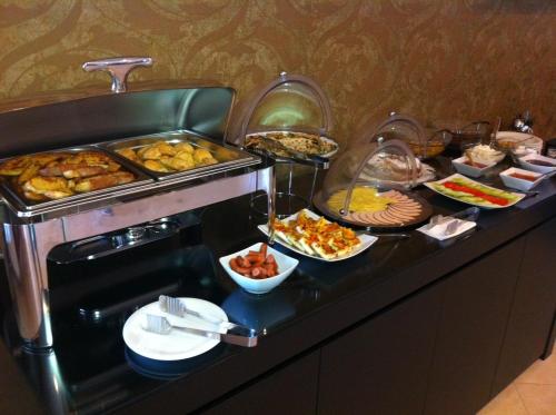 a buffet line with many different types of food at Byzantinon Hotel in Leonidion