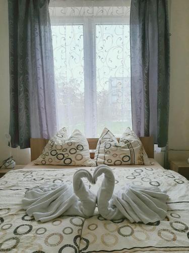a bed with two white towels on it with a window at HOTEL RADOMSKO in Radomsko
