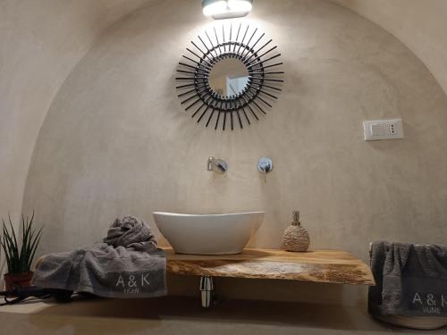 a bathroom with a sink and a mirror on the wall at A&K HOME in Ceglie Messapica