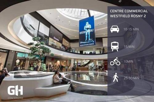 a shopping mall with people sitting in the middle of it at Le Cosy Paddock - Balcon - Proche Gare in Noisy-le-Sec