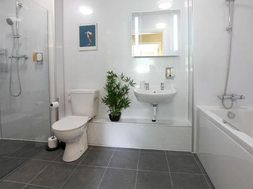 a bathroom with a toilet and a sink at Netherwood in Bakewell