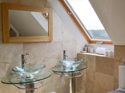 a bathroom with two glass sinks and a mirror at The Farm House in Wolsingham