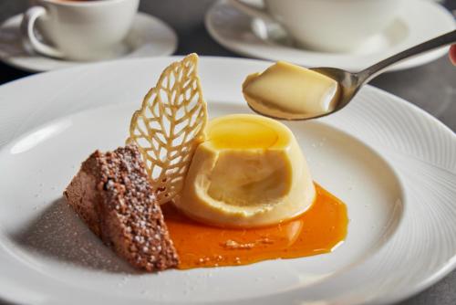 a white plate with a dessert on a table at Beacon Hill Hotel in Boston