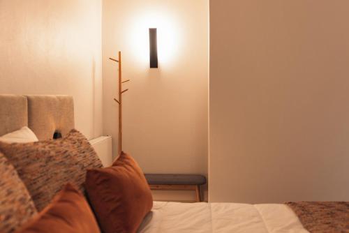 a bedroom with a bed with a light on the wall at Casa da Ribeira in Marco de Canavezes