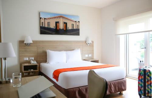 a hotel room with a large bed and a desk at Casa Andina Standard Miraflores San Antonio in Lima