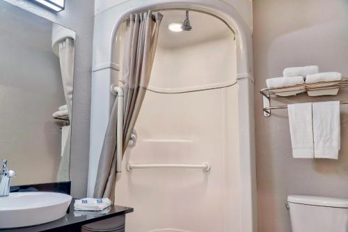 a bathroom with a shower and a toilet and a sink at Motel 6-El Monte, CA - Los Angeles in El Monte