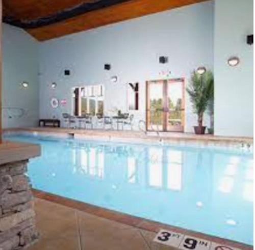 a large swimming pool in a building at Monroe’s Chateau with Hot Tub in Angel Fire