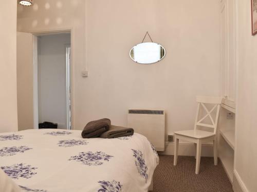a bedroom with a bed and a mirror on the wall at Flat 2 Beachview - Ukc4220 in Lowestoft