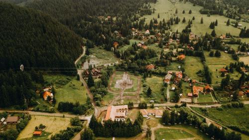 an aerial view of a village in a forest at Casa Roland in Gheorgheni